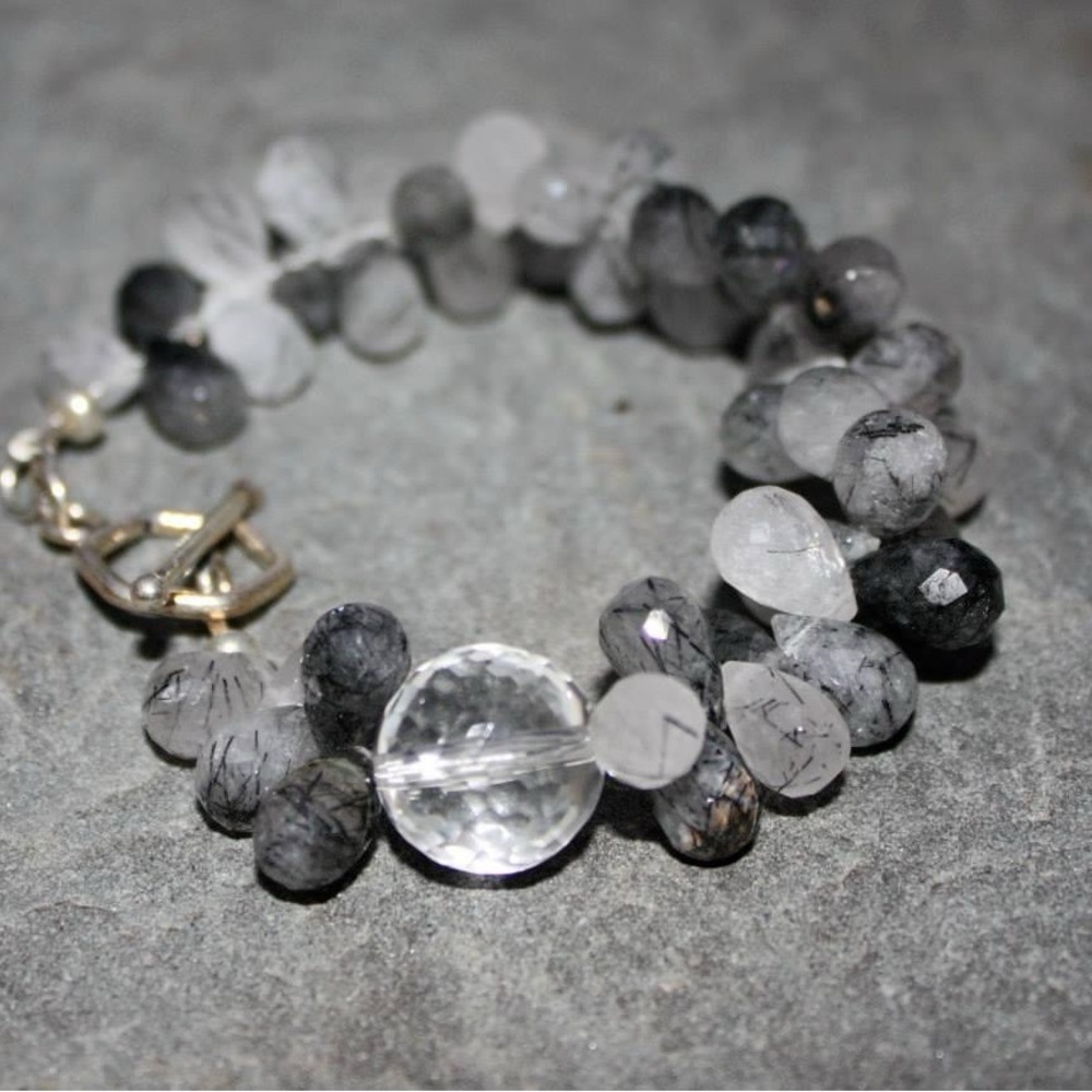 Round, Faceted Rutilated Quartz bracelet with rock quartz accent. Sterling clasp